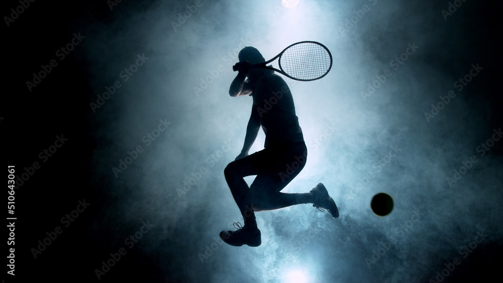 Dramatic tennis player silhouette jumping up in the air