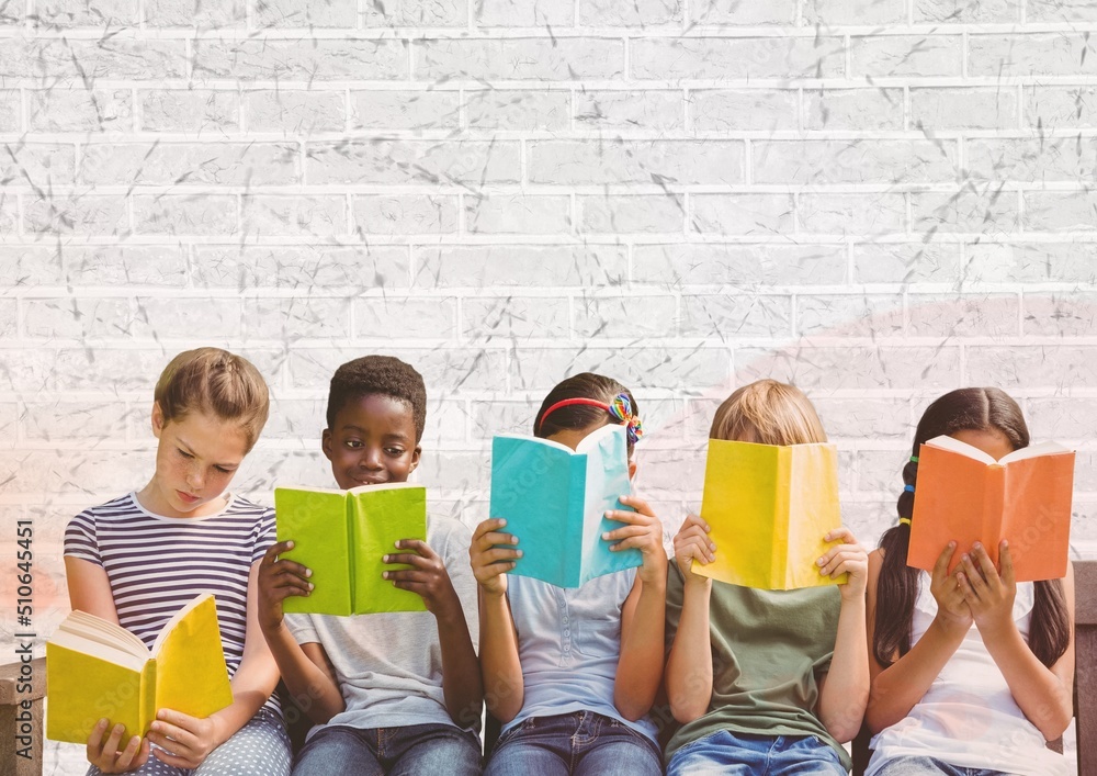 Group of diverse students reading books against grey brick wall background with copy space