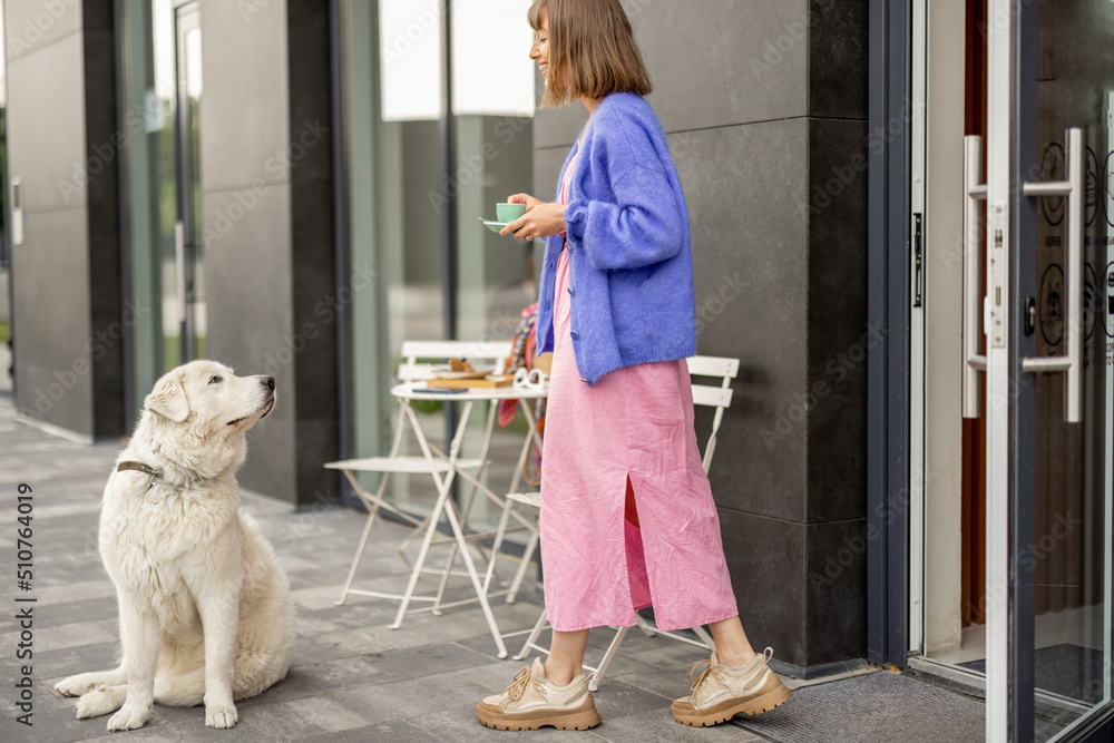 Woman with dog at cafe outdoors