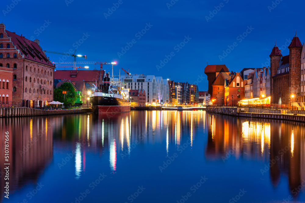 Beautiful Gdansk city reflected in the Motlawa River at dusk. Poland