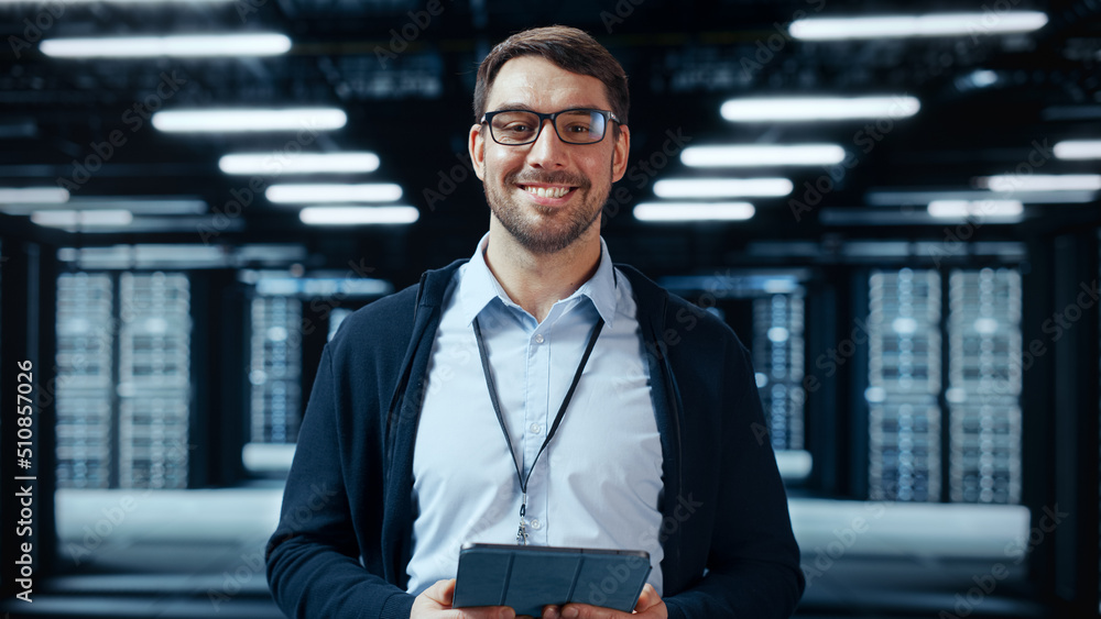 Portrait of a Bearded Handsome Caucasian IT Specialist in Glasses Standing with Tablet and Posing in