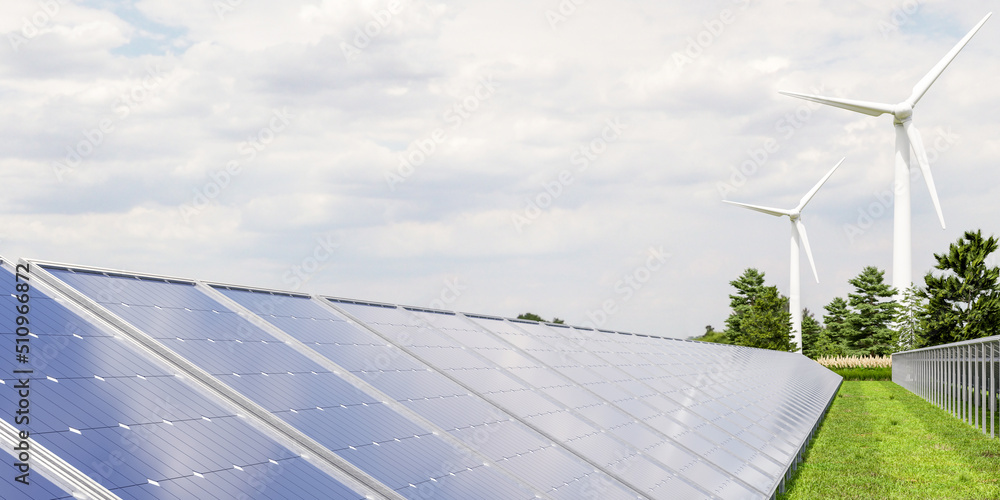 Solar panels and wind turbine on the sky background.