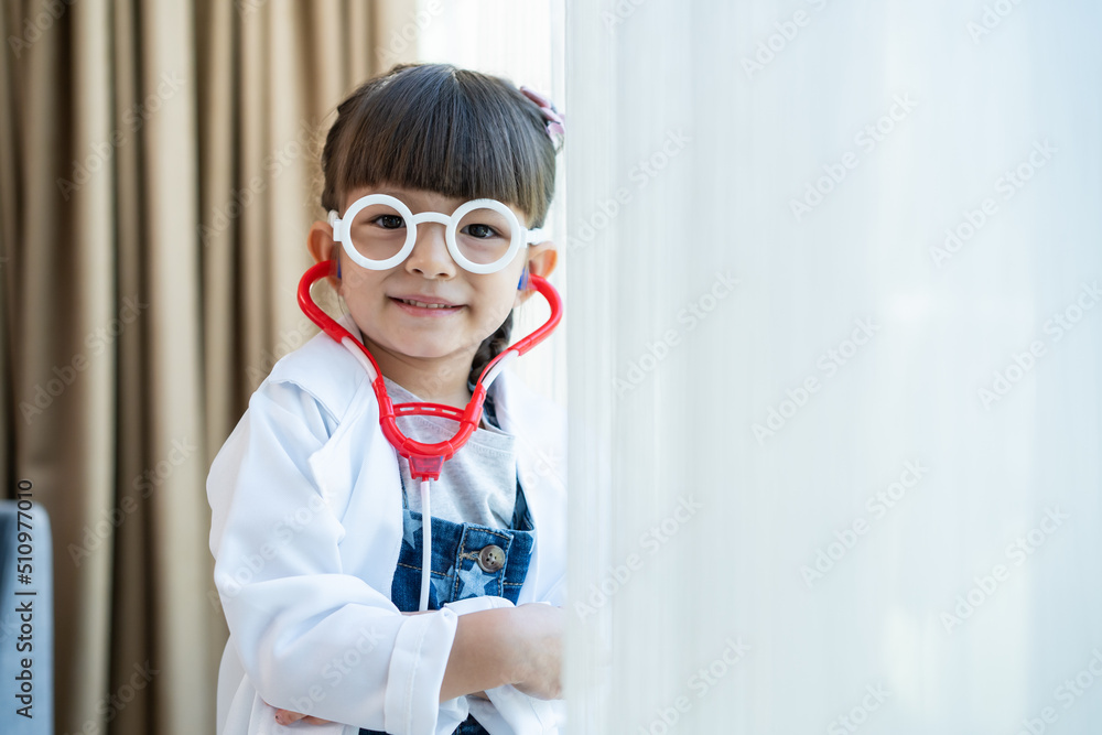 Portrait of Caucasian girl wear doctor uniform stand in living room. 