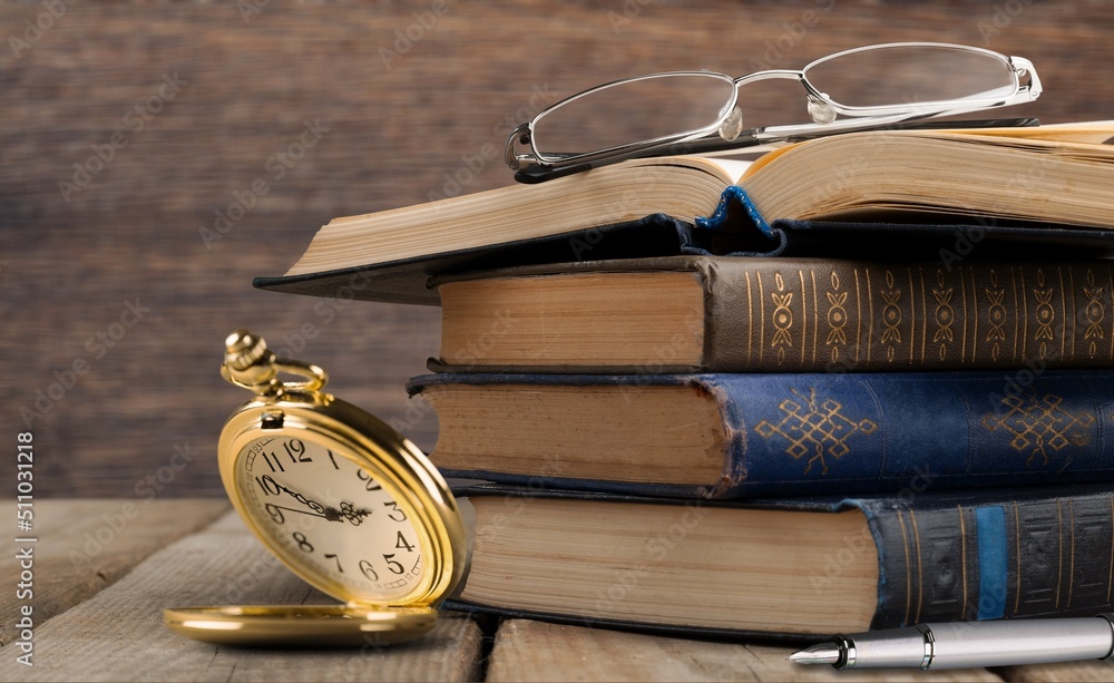 Beautiful old clock, old book on the desk