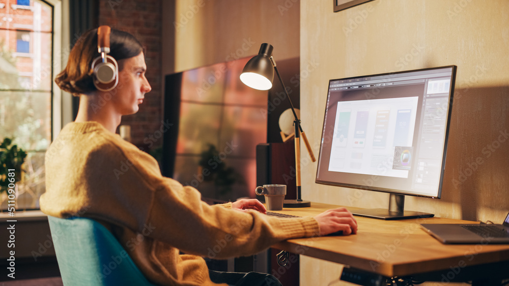 Young Handsome Man Working from Home on Desktop Computer in Sunny Stylish Loft Apartment. Creative D