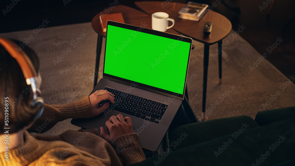 Young Man Working from Home on Desktop Computer with Green Screen Mock Up Display. Creative Male Wea