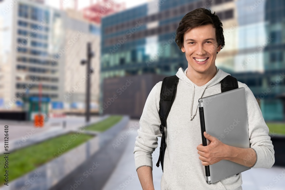 Overjoyed excited man holding laptop while looking at camera