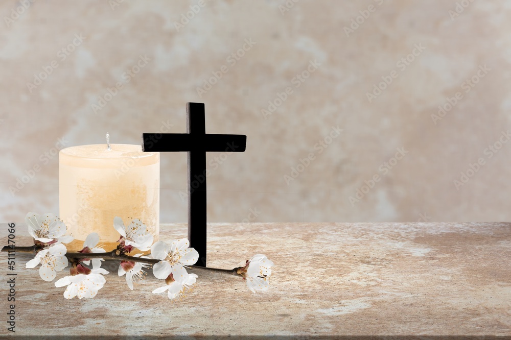 Wooden cross, flowers and candles on table. Religious church holiday. symbol of faith in God, Christ