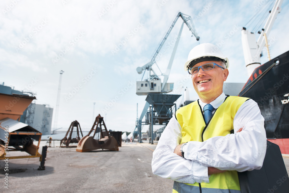 I live for my job. A dock worker standing at the harbor amidst shipping industry activity.