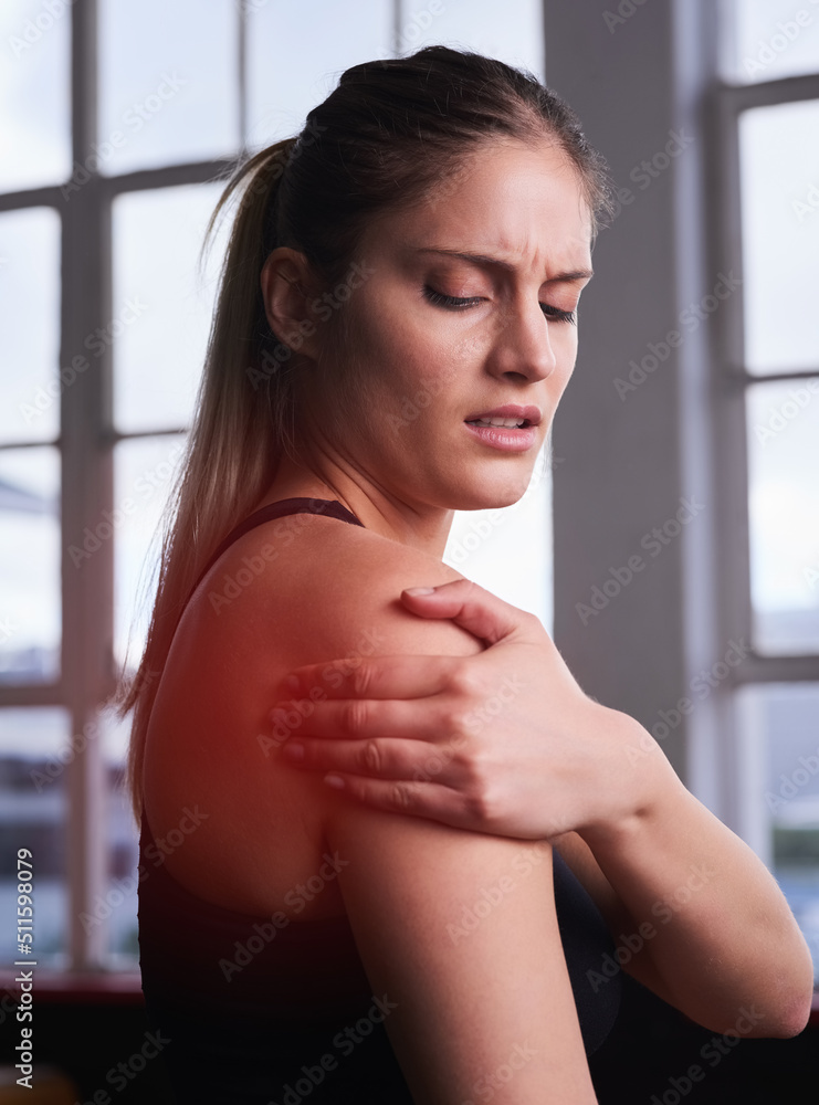 Want to know why stretching is important.... Shot of a sporty young woman holding her injured should