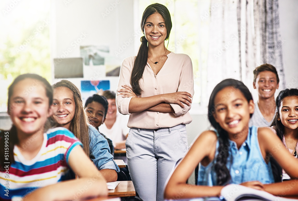 Their favourite class with their favourite teacher. Portrait of an attractive young teacher standing