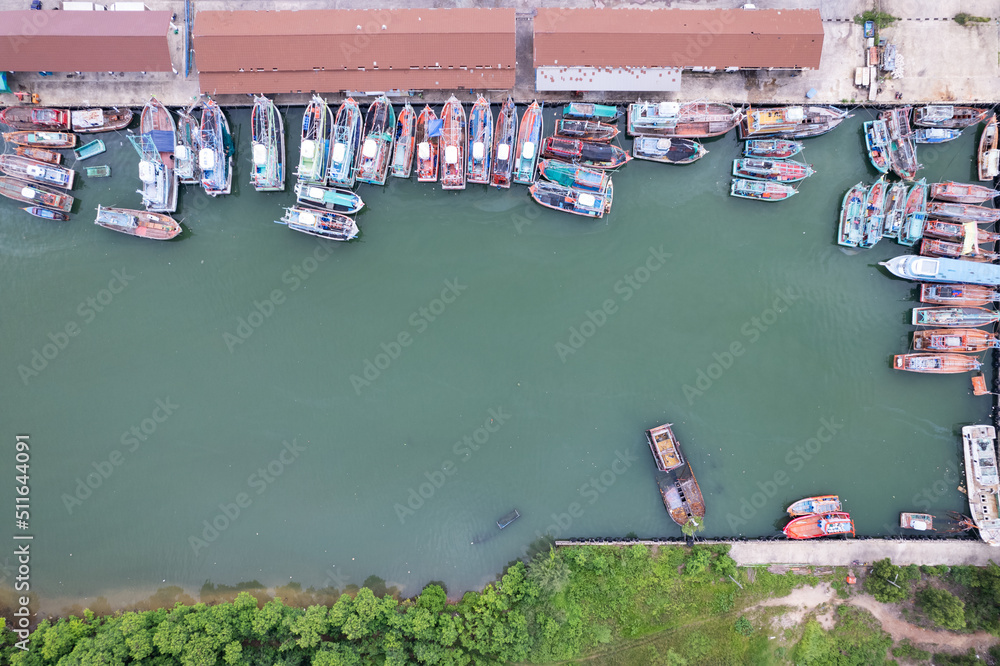 Aerial top view of the many fisherman boats with big fishing port at the pier in Phuket Thailand. hi