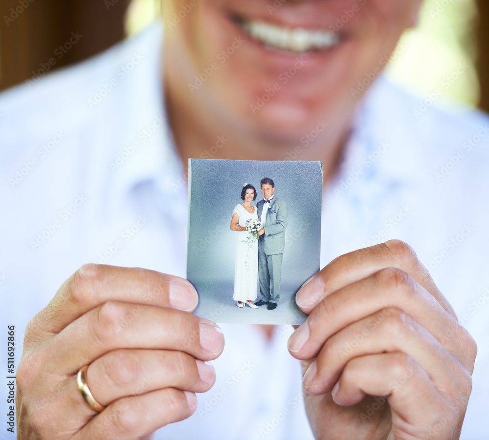 The day we got married.... Cropped image of a person holding up an old wedding photo.