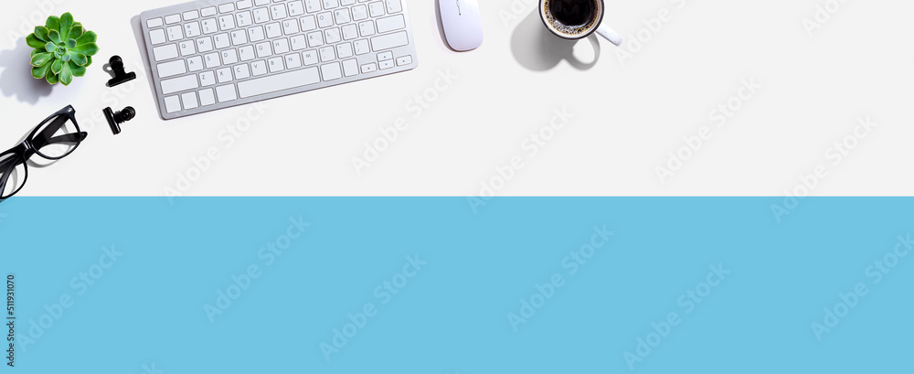 Computer keyboard with a cup of coffee and eyeglasses - flat lay