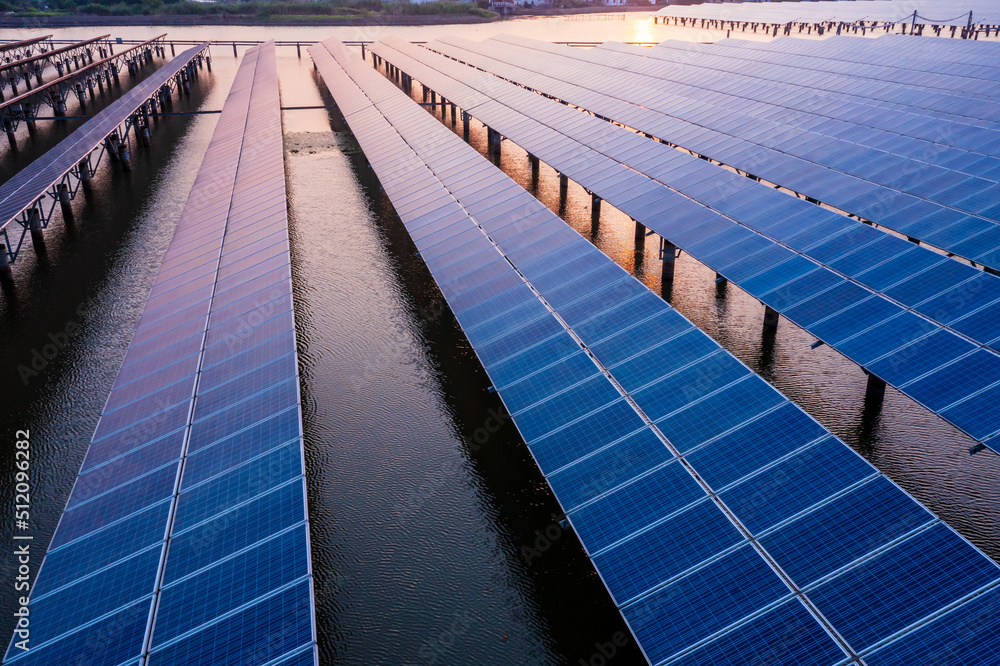 Solar power station at beautiful sunset. solar photovoltaic power station on water. green energy con