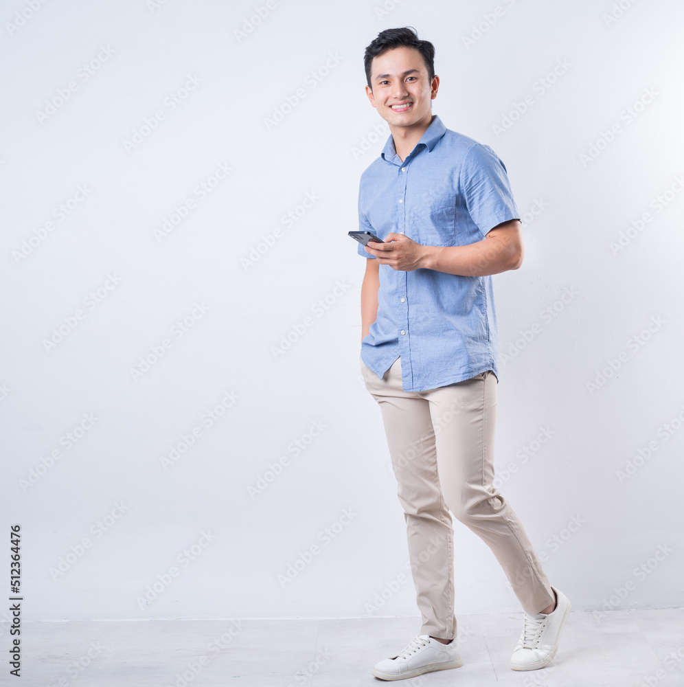 Full length image of young Asian man on white background