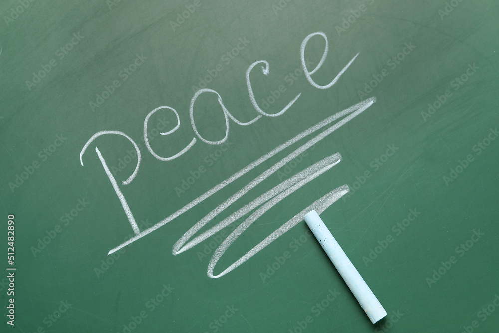 Word PEACE with chalk on school blackboard