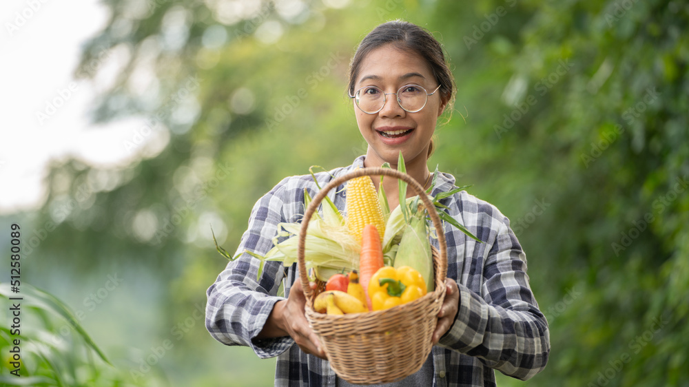 Beautiful young brunette Portrait Famer Woman hand holding Vegetables in the bamboo basket on green 