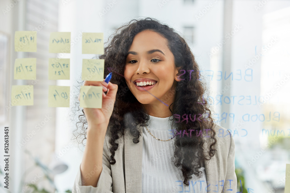 Setting goals keeps you focused and on track. Shot of a young businesswoman brainstorming with notes