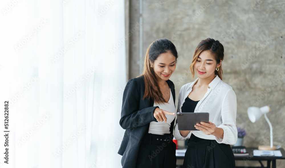 微笑的女商人站在现代办公室内部与伴侣交谈，教授团队