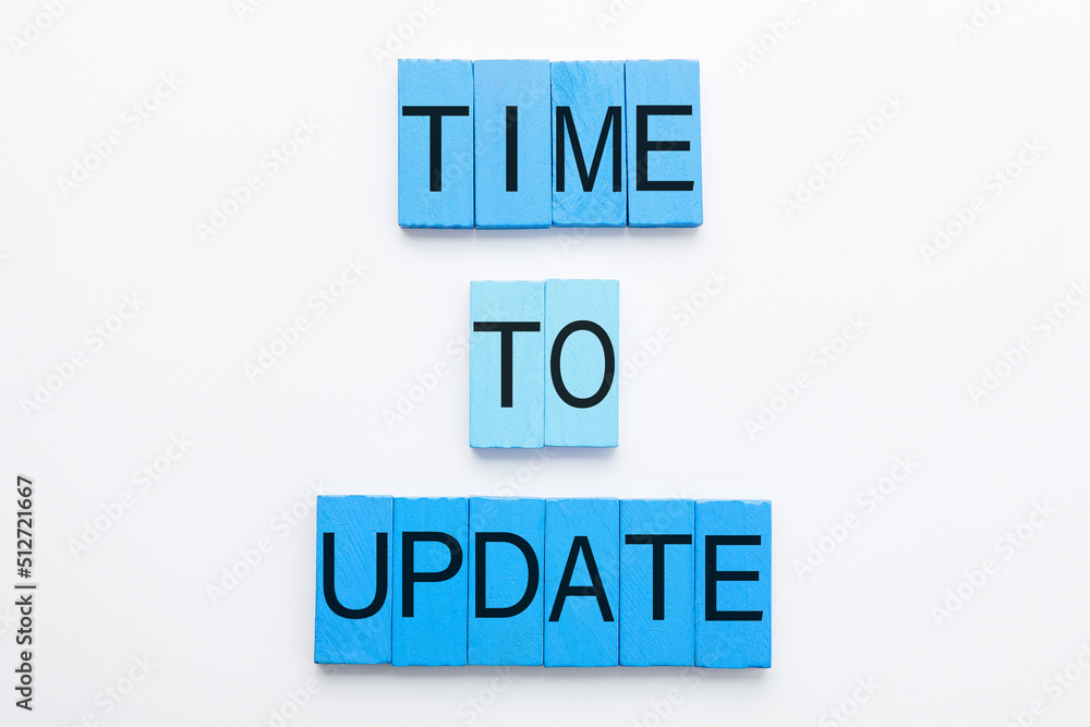 Text TIME TO UPDATE made of blue wooden blocks on white background