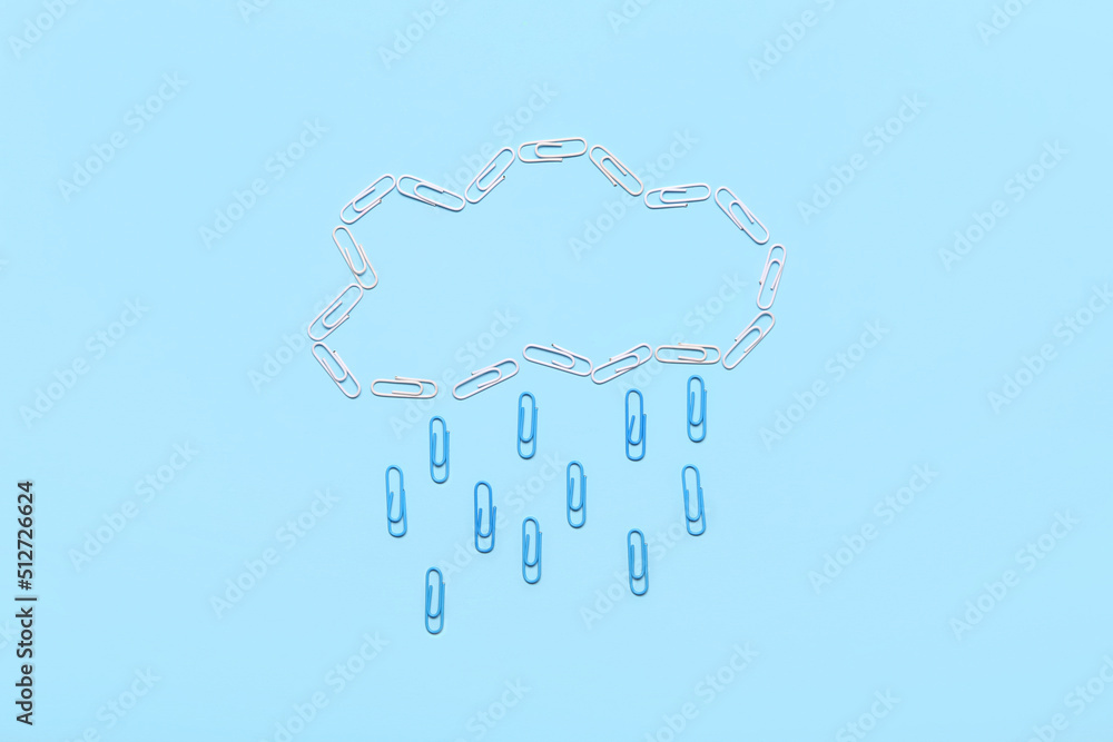 Rain cloud made of paper clips on blue background