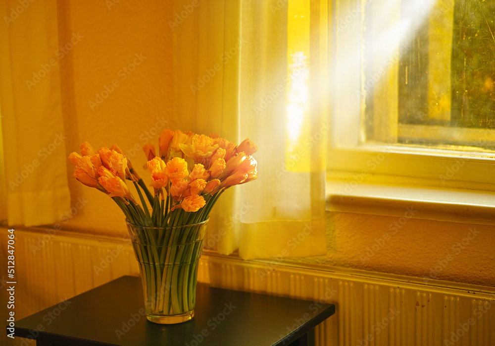 Gorgeous bouquet of fresh tulips flowers on a table in empty house. Fresh summer oranges flowers sym