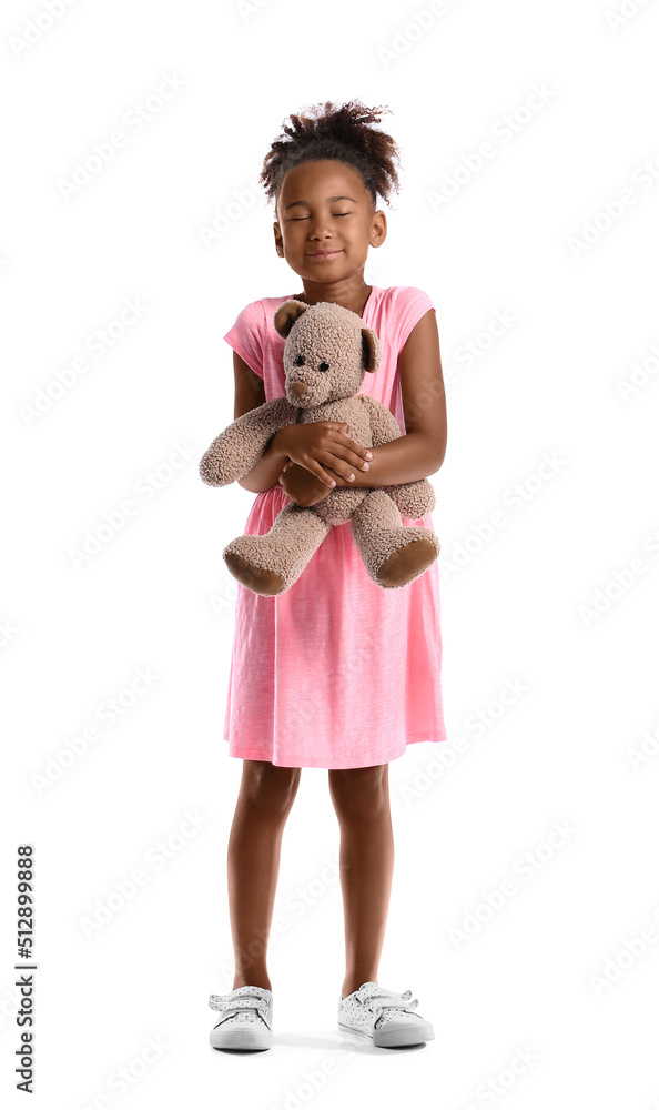 Little African-American girl with teddy bear on white background