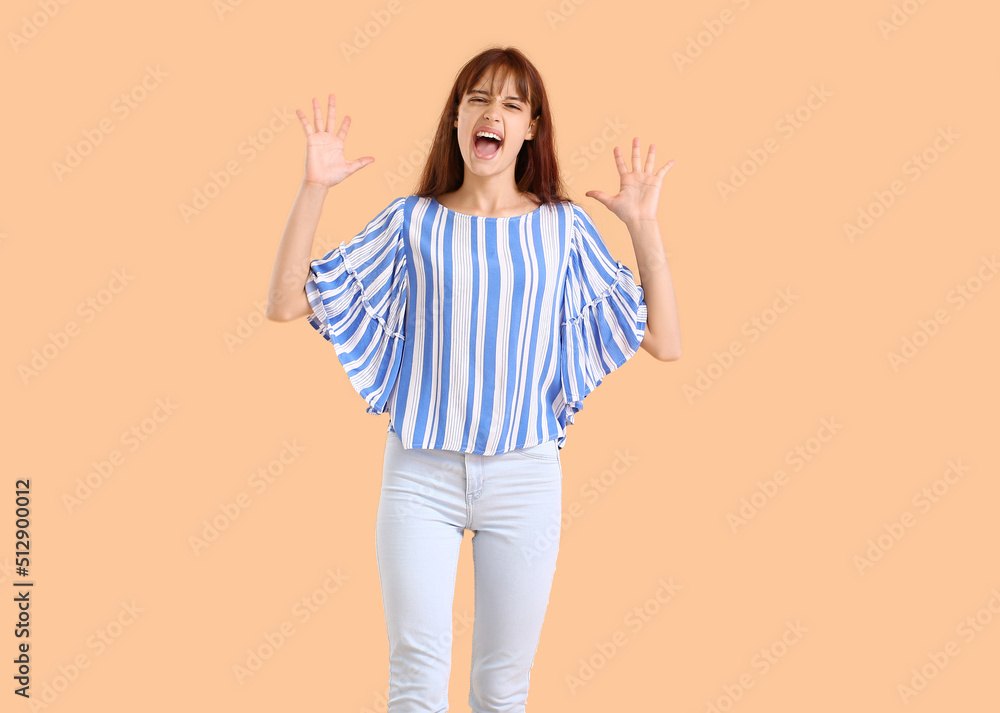 Teenage girl shouting on beige background