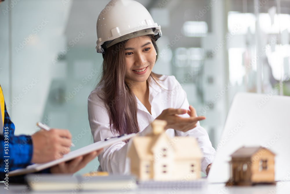 Happy female architect designer in the office works with her colleagues, engineers, contractors toge