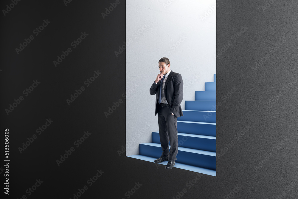 Attractive thoughtful young european businessman standing in abstract concrete wall opening with blu