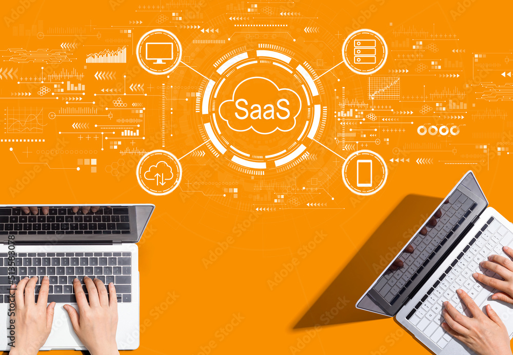 SaaS - software as a service concept with people working together with laptop computers