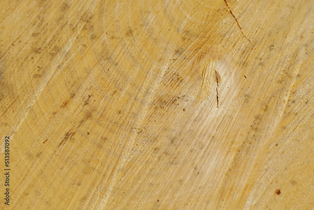 Closeup of scratches on old wood. Detail of rough textures on a used chopping board. Wooden material