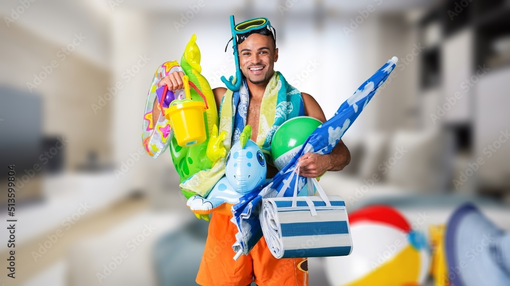 Funny crazy man pretends to be swimming at home in living room. Having fun imagining that he is on b