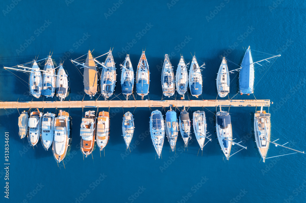 Aerial view of boats and luxure yachts in dock at sunset in summer in Pula, Croatia. Colorful landsc