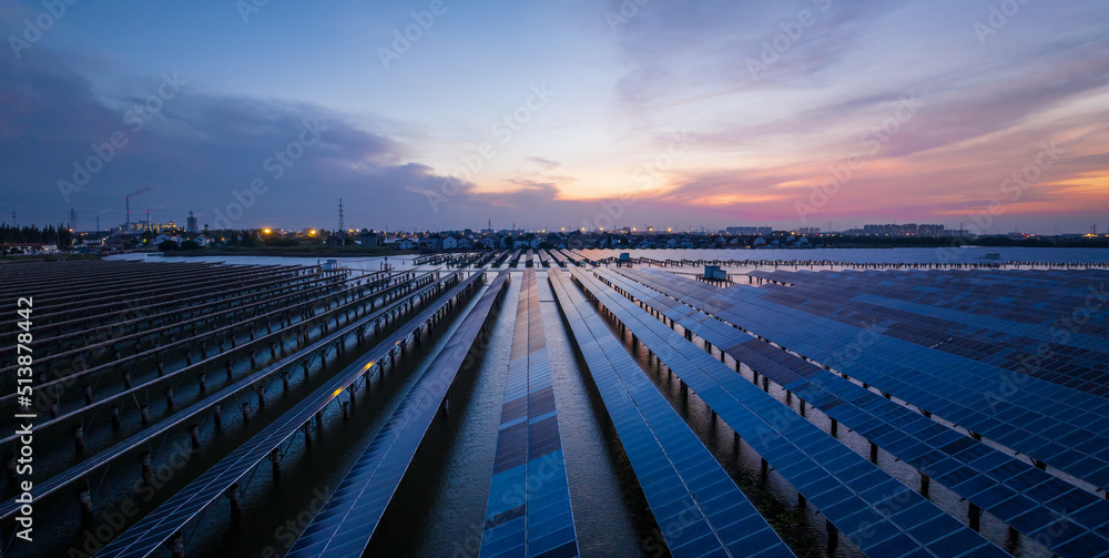 Aerial view of solar power station at beautiful sunset. solar photovoltaic power station on water. g