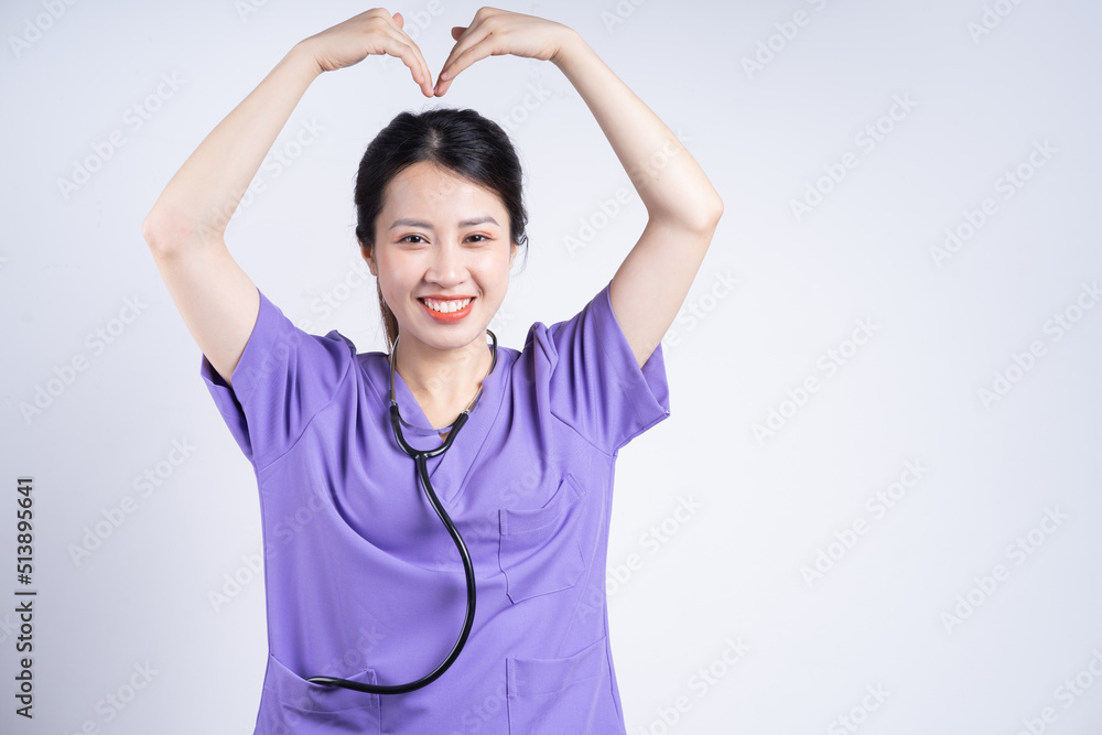 Portrait of young Asian nurse on white background