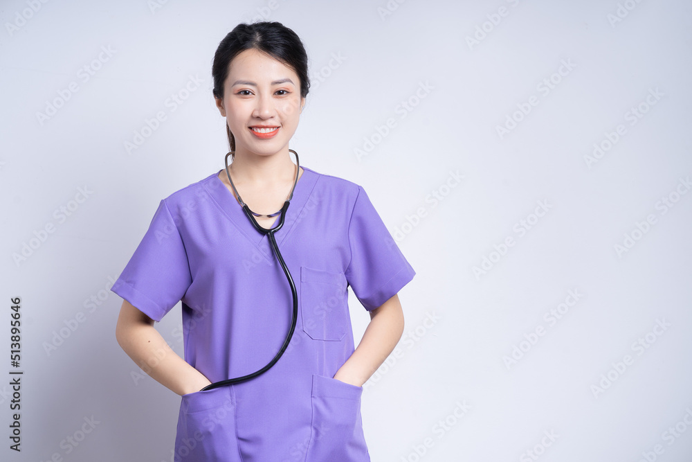 Portrait of young Asian nurse on white background