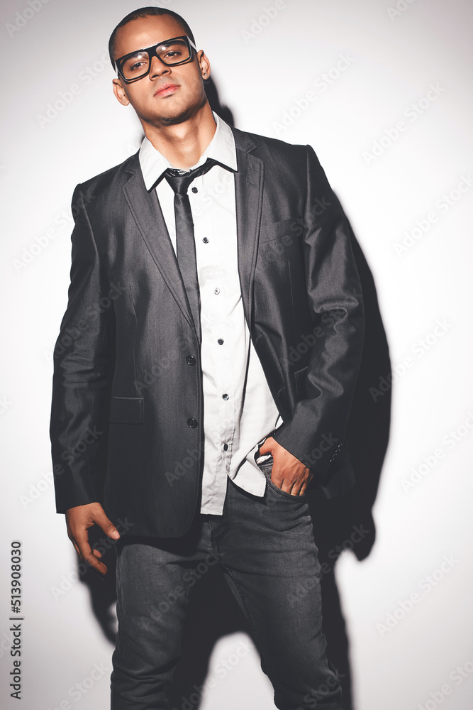 Man fashion model posing against a studio background