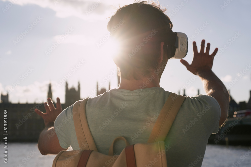 Rearview shot of a man using a virtual reality headset while exploring the city of London