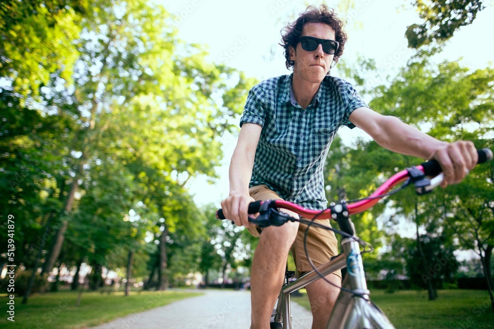 Cyclist riding in a city park.