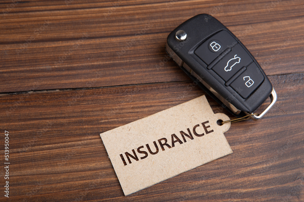 Car insurance concept. Vehicle security key with tag on the