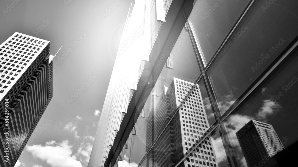 Modern office building with glass facade on a clear sky background. Transparent glass wall of office