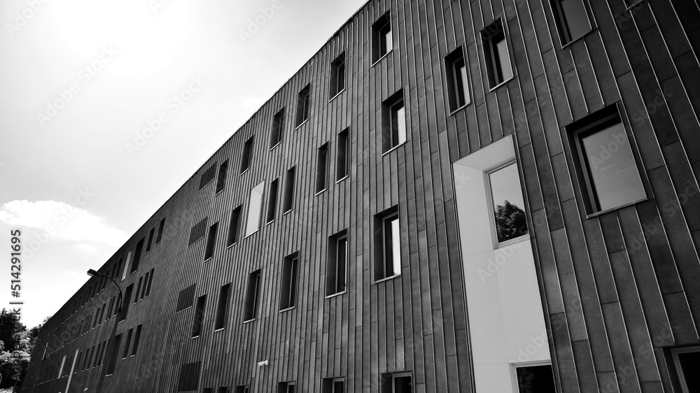 Fragment of modern urban geometry. Walls  office building made of steel and glass. Bright sunny day 