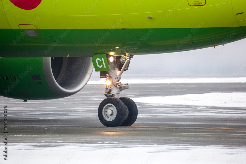 Front landing gear of a aircraft on the parking lot of the airfield