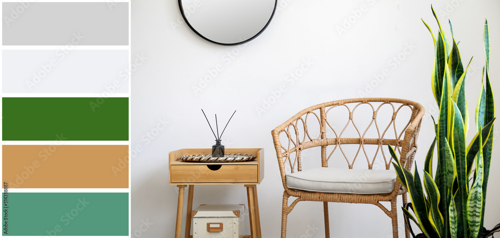 Wicker chair, houseplant and table near light wall in room. Different color patterns