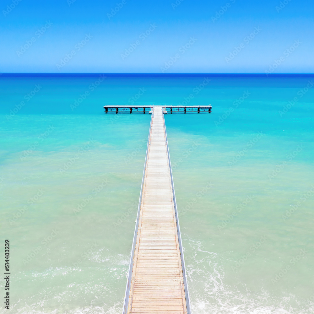 Wooden pier out to sea perspective, view from above