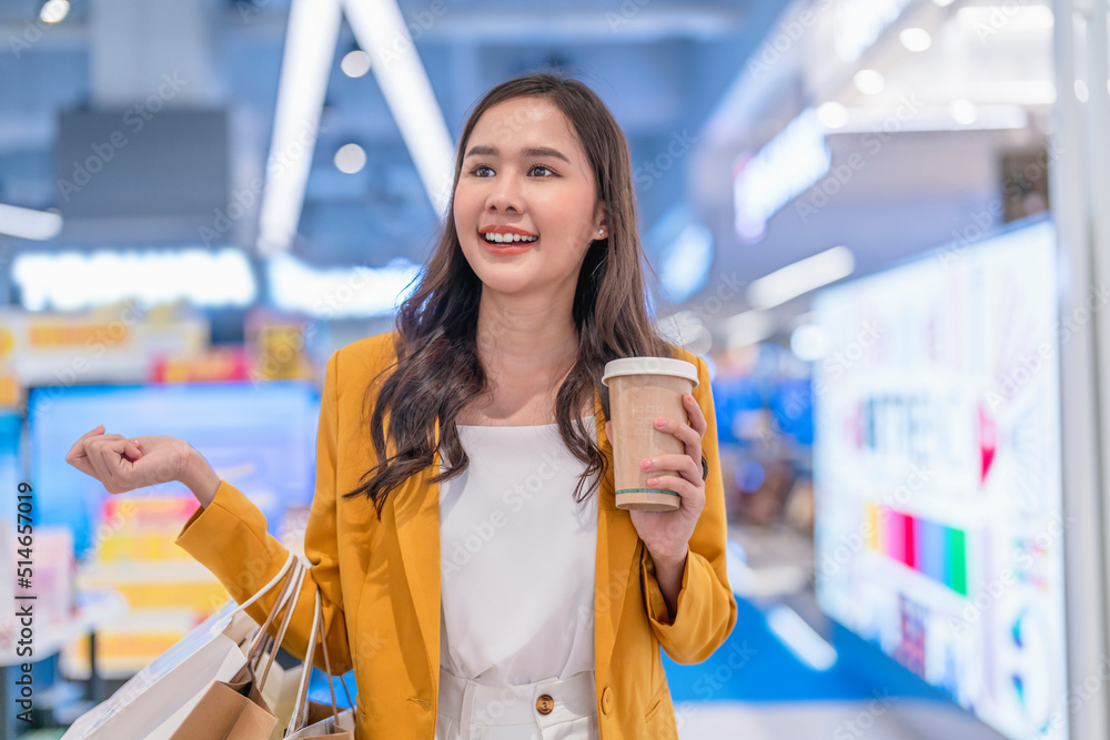 Beautiful asian female woman girl is holding shopping bags and coffee drink, walk and cheerful enjoy