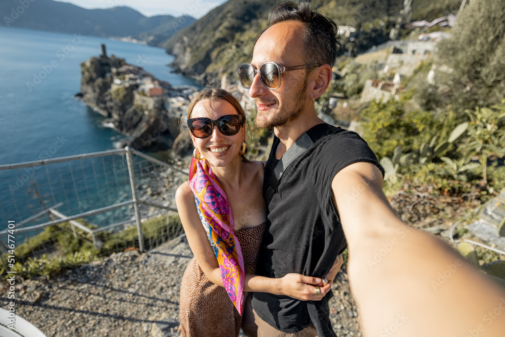 Selfie photo of couple on background of mediterranean coast in Italy. Traveling famous Cinque Terre 