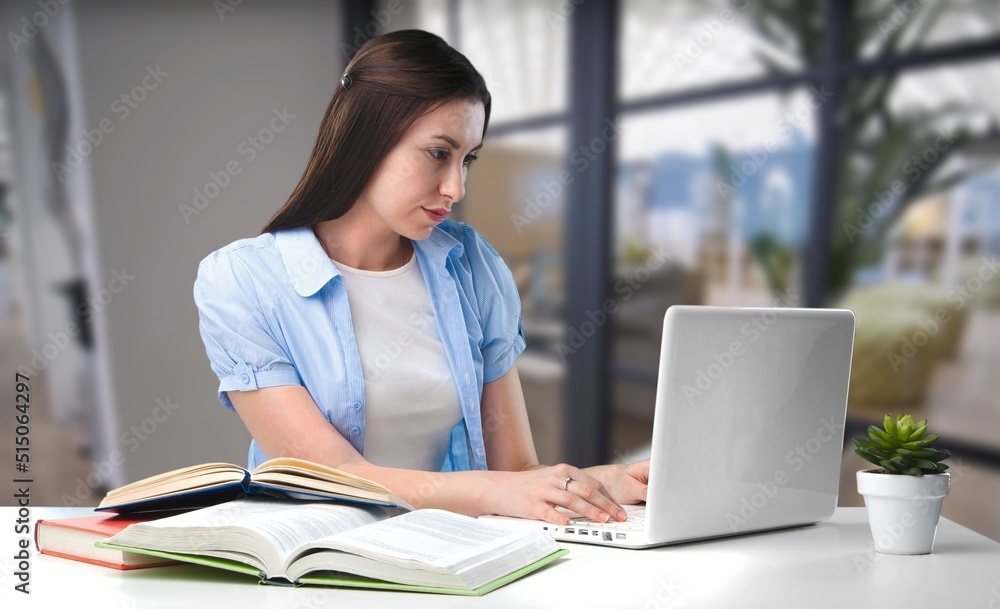 Business woman sit at table make correction in document, check data, student prepare essay, learn at